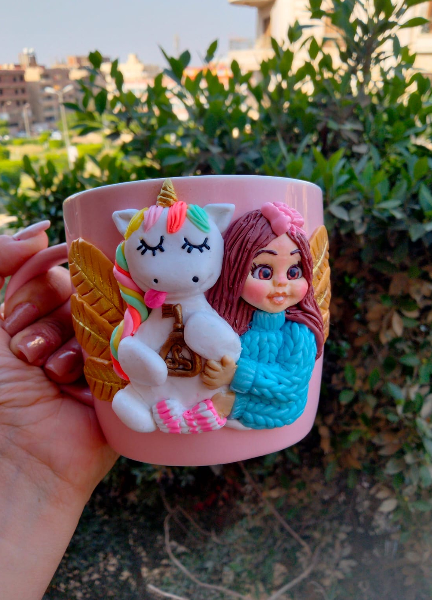 Girl holding a unicorn mug